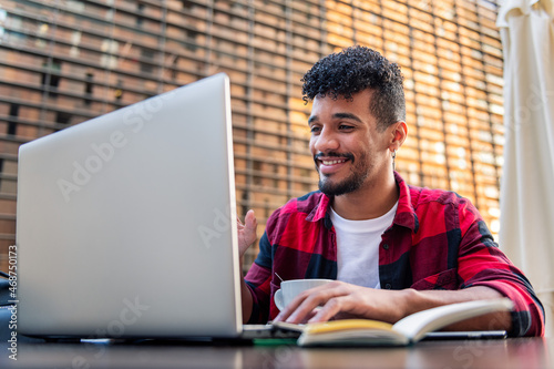 man smiles happy making video call from a terrace