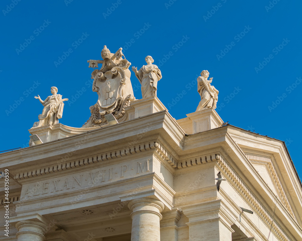 North colonnade saints statues and coat of arms in Piazza San Pietro (St. Peter's Square) in Vatican city, Rome, Italy 