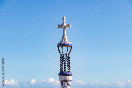 Cross in the entrance of The famous Parc Güell designed by the architect Gaudí in the city of Barcelona. photo