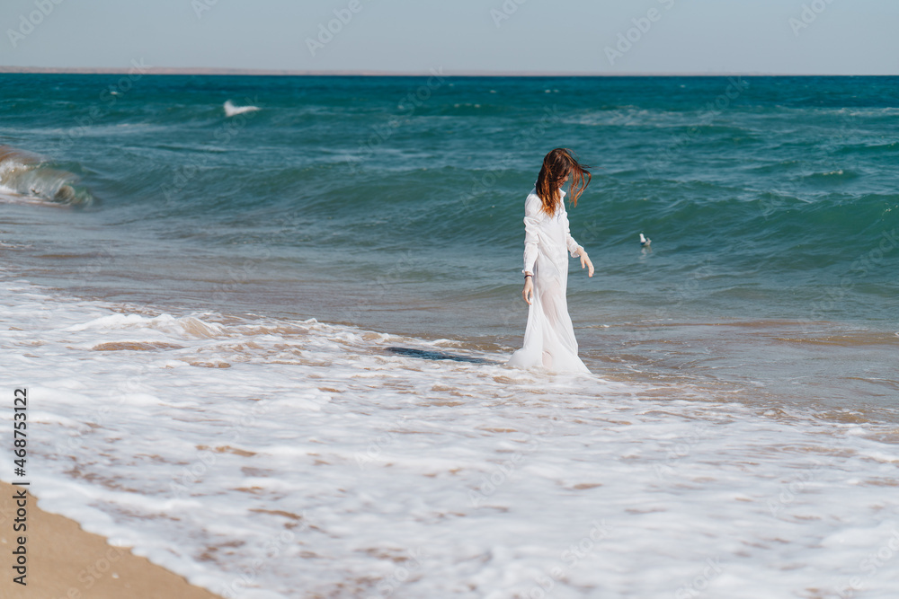 Woman in white dress near the ocean walk fresh air landscape Woman in white dress near the ocean walk fresh air landscape