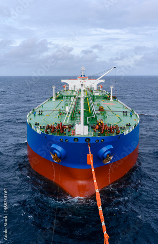 Crude oil transfer operation from floating storage of oil tanker to the export oil tanker using tandem mooring setup operation in open sea.