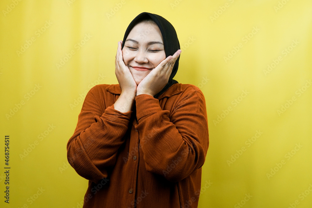 Beautiful young asian muslim woman smiling happy, cute, feeling comfortable, feeling cared for, feeling good, with hands holding cheeks isolated Beautiful young asian muslim woman smiling happy, cute, feeling comfortable, feeling cared for, feeling good, with hands holding cheeks isolated