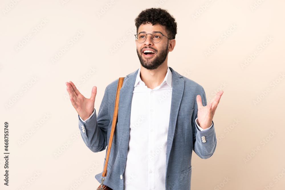 Young business Moroccan man isolated on beige background with surprise facial expression Young business Moroccan man isolated on beige background with surprise facial expression