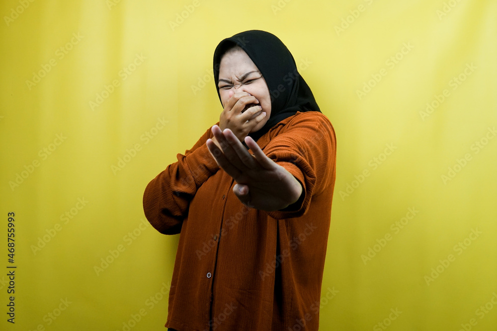 Beautiful young asian muslim woman with hand covering mouth, refusing something isolated Beautiful young asian muslim woman with hand covering mouth, refusing something isolated