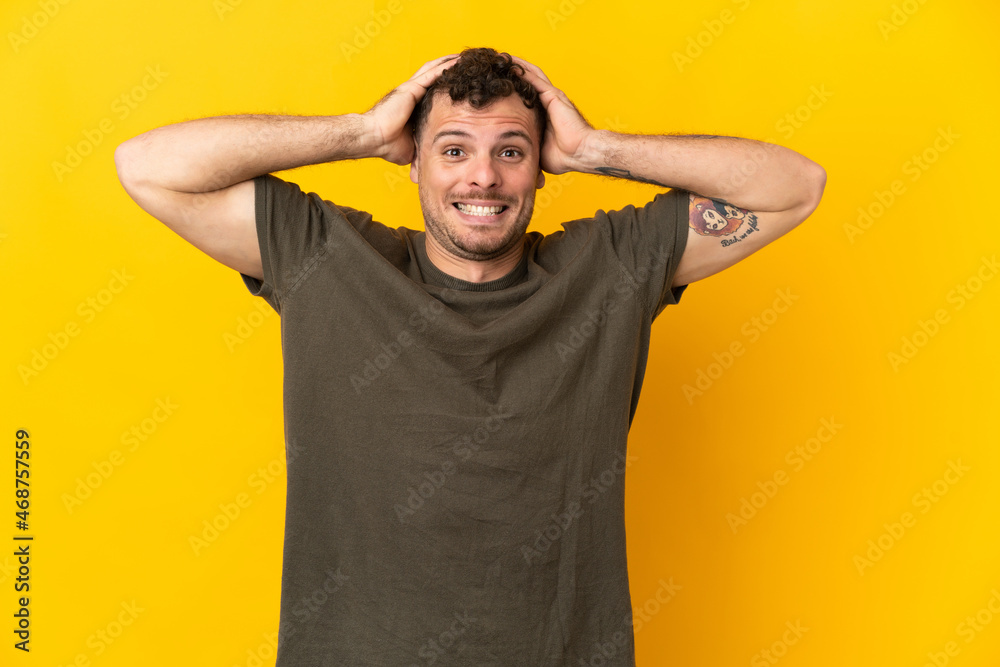Young caucasian handsome man isolated on yellow background doing nervous gesture Young caucasian handsome man isolated on yellow background doing nervous gesture