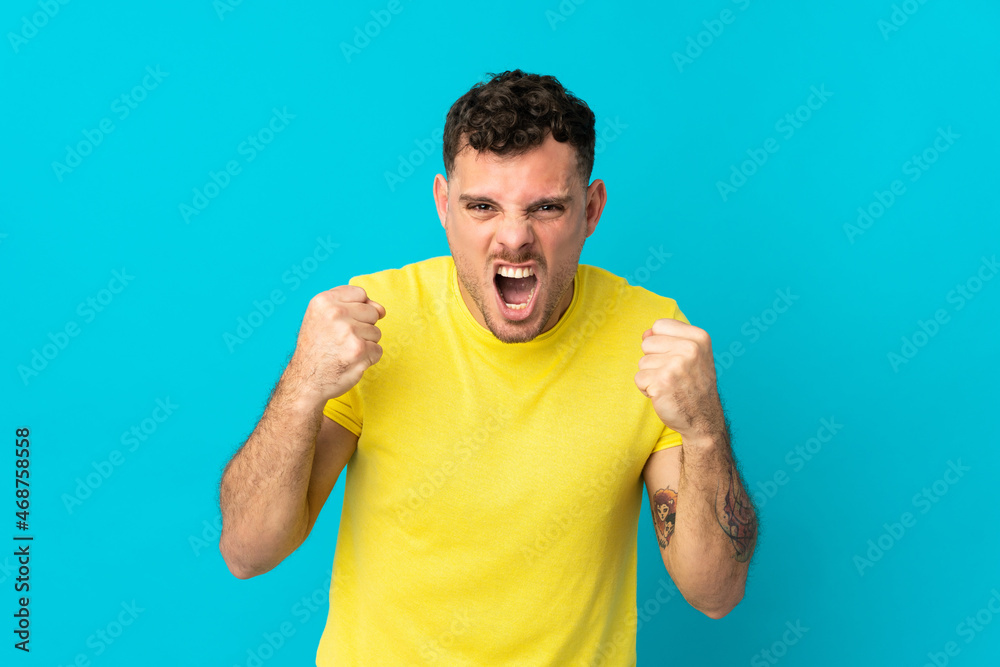 Young caucasian handsome man isolated on blue background frustrated by a bad situation Young caucasian handsome man isolated on blue background frustrated by a bad situation