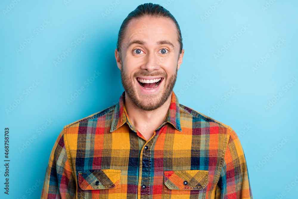 Photo of cool young tail hairdo guy open mouth wear yellow shirt isolated on blue color background Photo of cool young tail hairdo guy open mouth wear yellow shirt isolated on blue color background