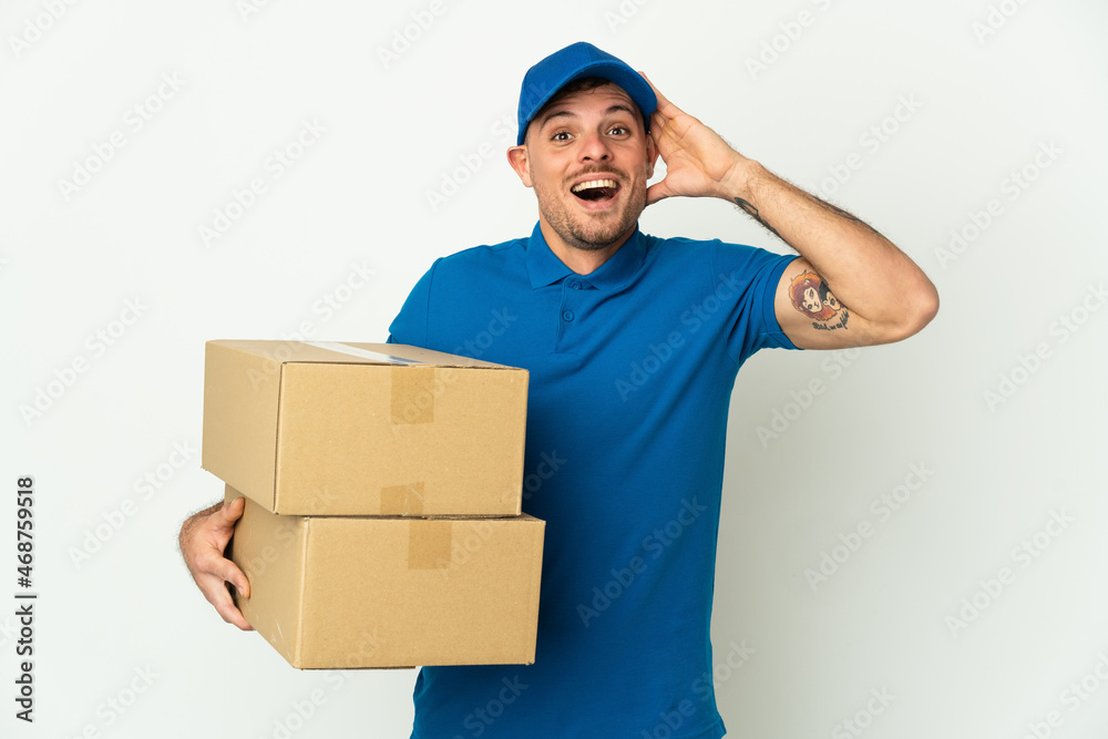 Delivery caucasian man isolated on white background with surprise expression