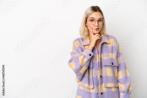 Young caucasian woman isolated on white background and thinking © luismolinero