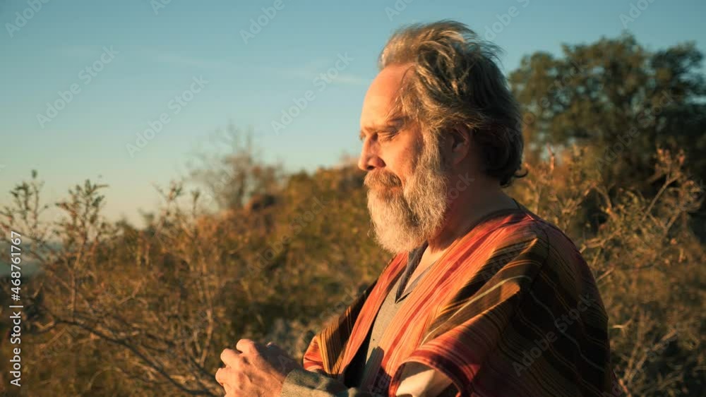 A Biblical prophet or holy man bows his head in prayer close up Stock