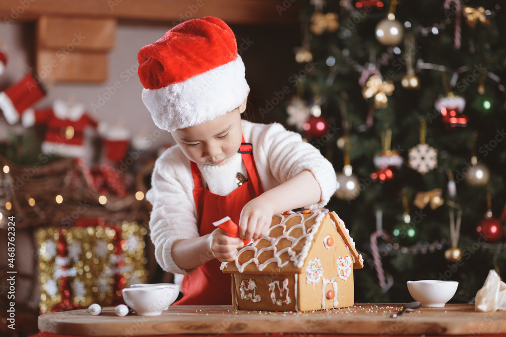 young girl making gingerbread house at home young girl making gingerbread house at home