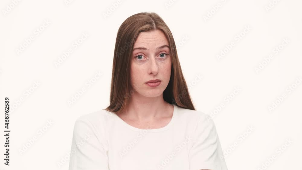 Positive woman showing foolish gesture in white studio Positive woman showing foolish gesture in white studio