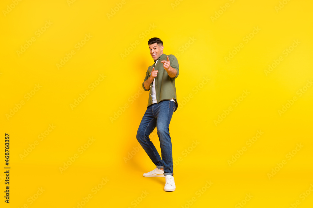 Full body photo of young guy happy positive smile point fingers you choice select isolated over yellow color background Full body photo of young guy happy positive smile point fingers you choice select isolated over yellow color background