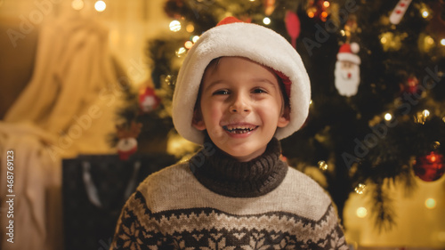 Portrait of cheerful laughing and smiling baby boy celebrating Christmas. Families and children celebrating winter holidays.