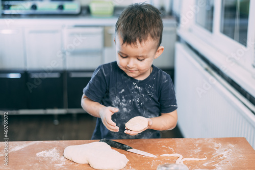 The child makes dough dumplings or dumplings is fun with enthusiasm
