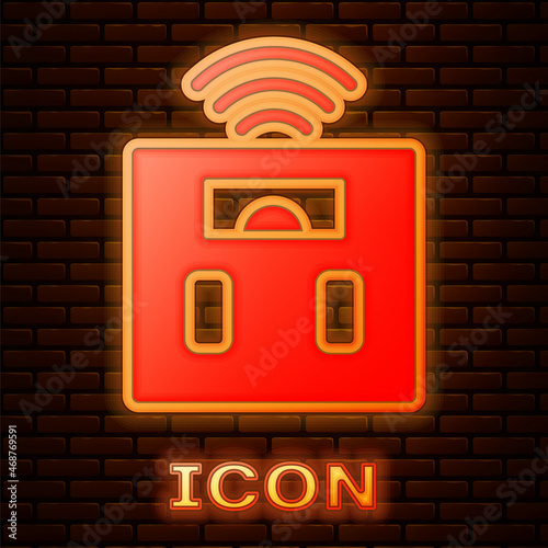 Glowing neon Smart bathroom scales icon isolated on brick wall background. Weight measure equipment. Internet of things concept with wireless connection. Vector