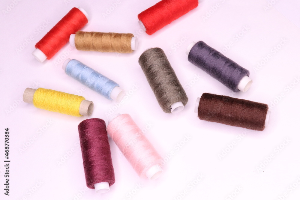 Spools of thread in different colors on a white background Spools of thread in different colors on a white background