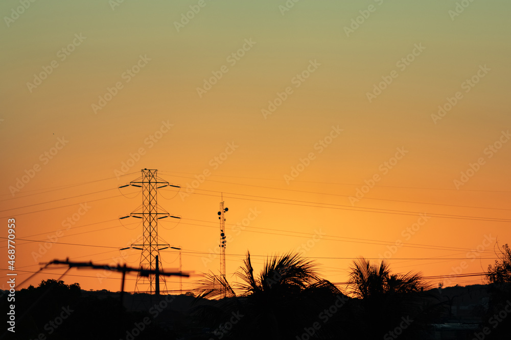 
antenna transmission line at sunset silhouette of tower