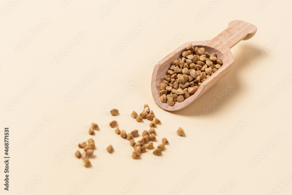 Wooden Scoop with Buckwheat on Yellow Background Horizontal Copy Space Concept for Healthy Eating and Nutrition Wooden Scoop with Buckwheat on Yellow Background Horizontal Copy Space Concept for Healthy Eating and Nutrition
