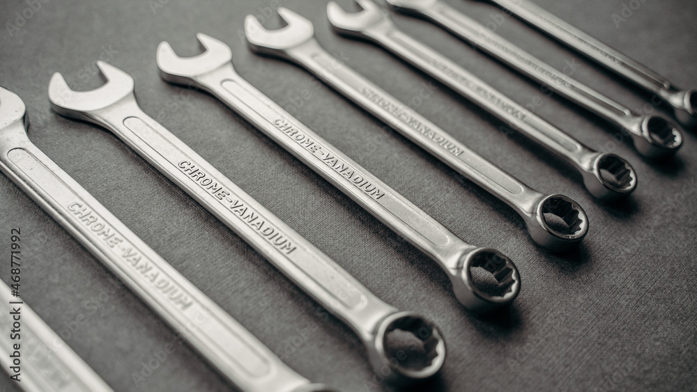 a set of wrenches of different sizes on a gray industrial background a set of wrenches of different sizes on a gray industrial background