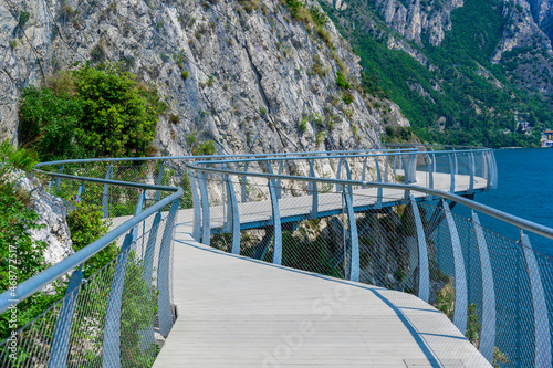 "Ciclopista del Garda" - Bicycle road and foot path over Garda lake with beautiful landscape scenery at Limone Sul Garda - travel destination in Brescia, Italy