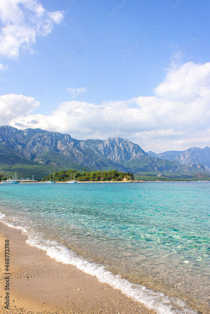 Seascape: clear blue sky, turquoise sea and mountains on the shore. Coastline of Kemer, Turkey. Seascape: clear blue sky, turquoise sea and mountains on the shore. Coastline of Kemer, Turkey.