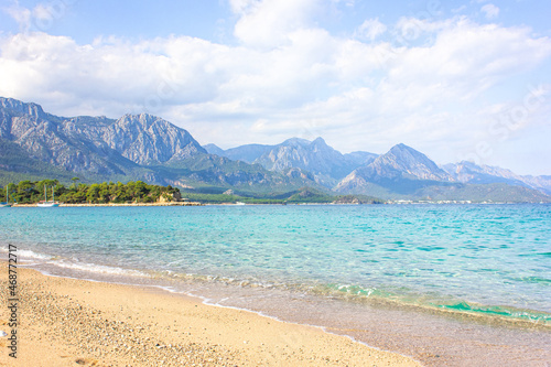 Seascape: clear blue sky, turquoise sea and mountains on the shore. Coastline of Kemer, Turkey.