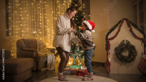 Laughing boy with mother dancing on Christmas party at home. Pure emotions of families and children celebrating winter holidays. © Кирилл Рыжов