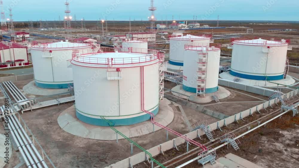 Oil production of the United States of America. The drone flies on tanks with oil, production and oil reserves in the world. Use of hydrocarbon fuels in industry. Drone flight over an oil field. Oil production of the United States of America. The drone flies on tanks with oil, production and oil reserves in the world. Use of hydrocarbon fuels in industry. Drone flight over an oil field.