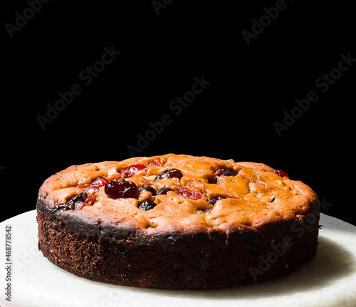 Closeup of traditional Christmas fruit cake  isolated on black background.