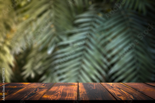 Fototapeta Naklejka Na Ścianę i Meble -  Jungle table background. Interior table for a cosmetic item against the backdrop of tropical plants, palms and jungle.