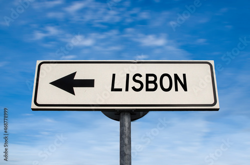 Lisbon road sign, arrow on blue sky background. One way blank road sign with copy space. Arrow on a pole pointing in one direction. Travel to Lisbon.