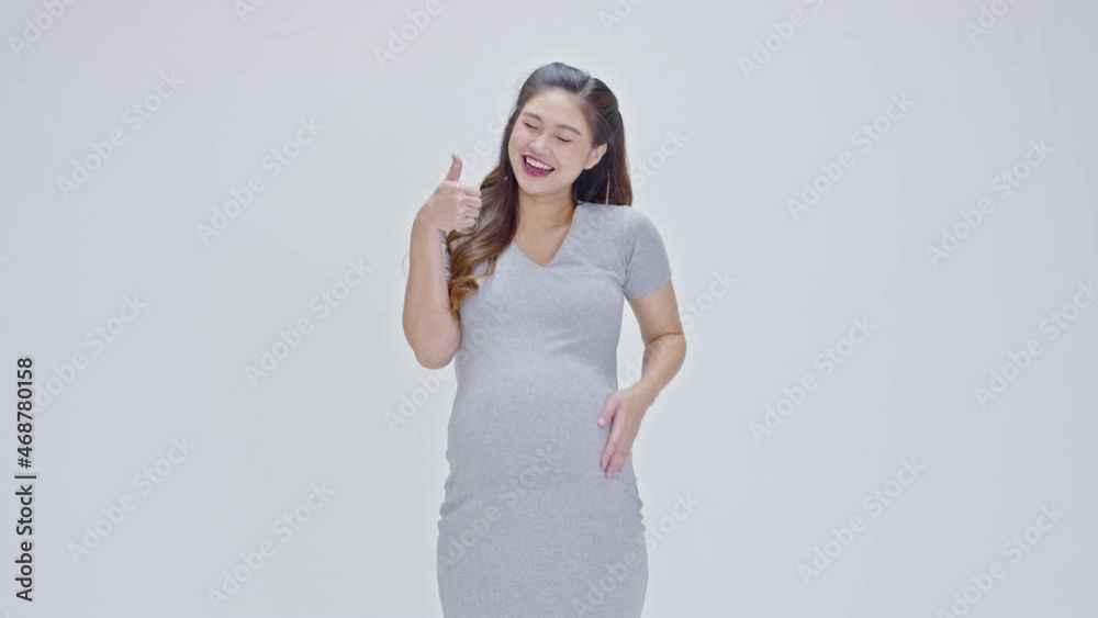 Happy Pregnant Woman standing smile stroking big belly with love and showing thumbs up sign isolated on white background,Pregnancy of young woman enjoy with future life,Motherhood and Pregnant Concept Happy Pregnant Woman standing smile stroking big belly with love and showing thumbs up sign isolated on white background,Pregnancy of young woman enjoy with future life,Motherhood and Pregnant Concept