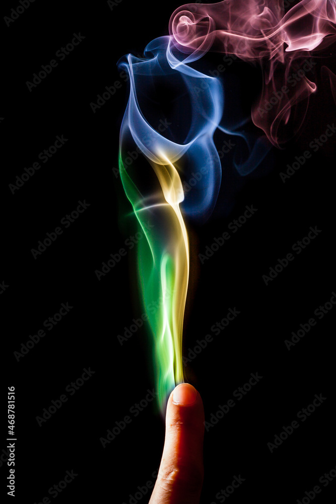 Obraz premium Colorful smoke out of fingers.