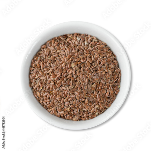 Brown linseed on a bowl isolated over white background