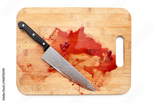 Cutting board with bloody surface and knife isolated on white. Top view © Savvapanf Photo ©