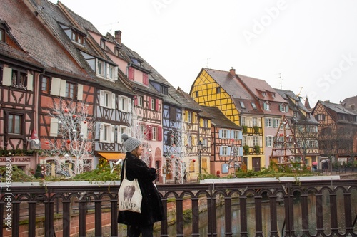 woman traveling in colmar, alsace at christmas