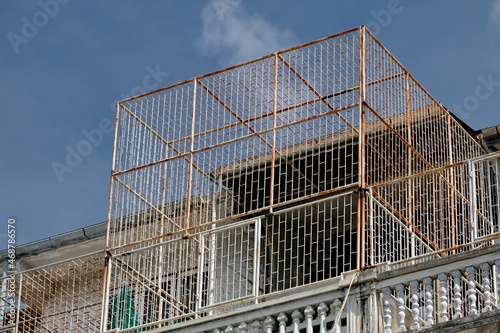 Building top floor rusty safety balcony grill © iFocus