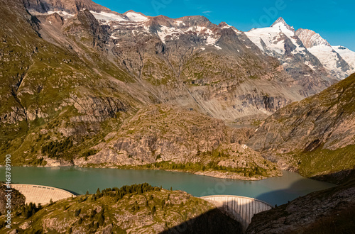 Beautiful alpine summer view with a reservoir and the famous Grossglockner summit in the background at the famous Grossglockner high Alpine road, Kaernten, Salzburg, Austria