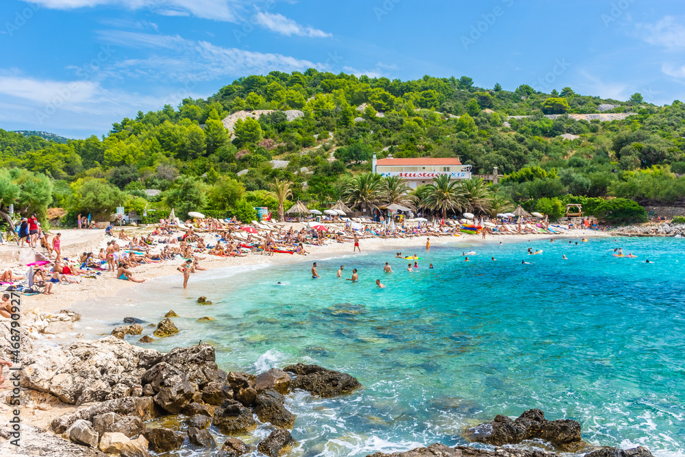HVAR, CROATIA, AUGUST 8 2019: The beautiful Pokoniji Dol Beach in Hvar Island, Adriatic Sea - obrazy, fototapety, plakaty 