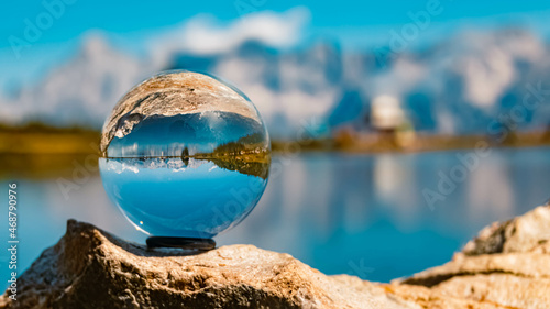 Crystal ball alpine landscape shot with reflections and the famous Dachstein mountains in the background at the Reiteralm, Pichl, Schladming, Steiermark, Austria