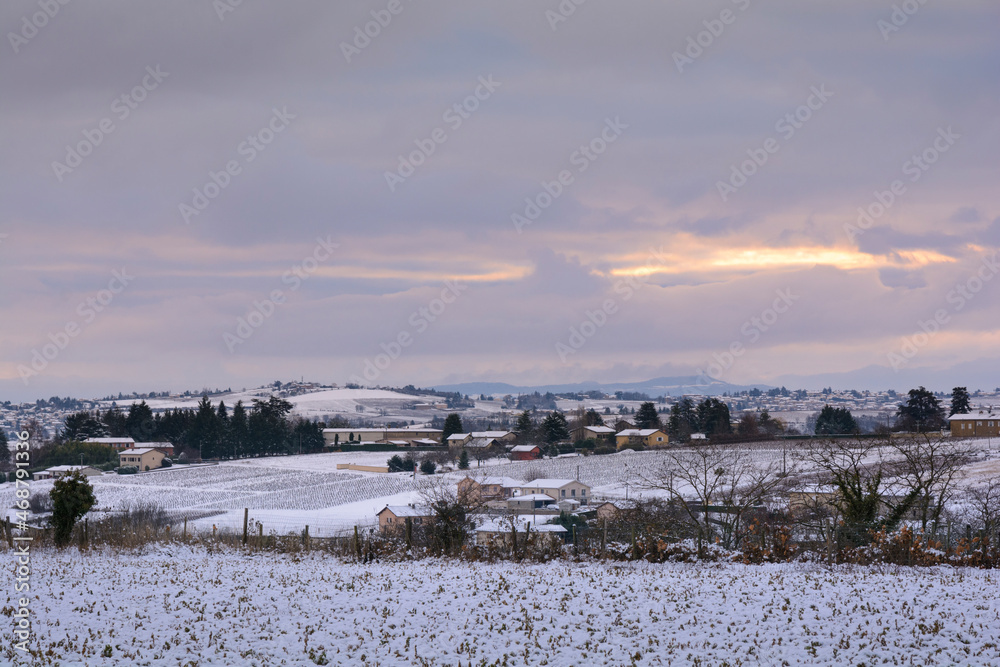 Snowed landscape and village of Beaujolais, France