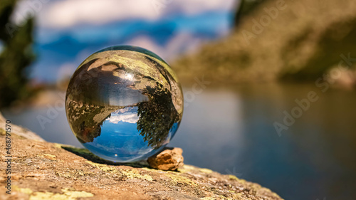 Crystal ball alpine landscape shot with reflections and the famous Dachstein mountains in the background at the Spiegelsee, Reiteralm, Pichl, Schladming, Steiermark, Austria