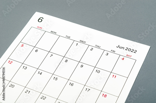 June 2022 calendar sheet on grey background.
