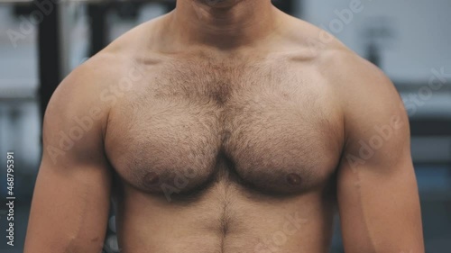 A man moves his strong and muscular chest