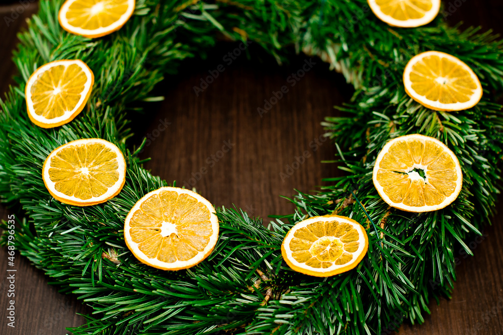 Christmas wreath of fir branches decorated with dried orange slices. Advent ornaments. Christmas wreath of fir branches decorated with dried orange slices. Advent ornaments.