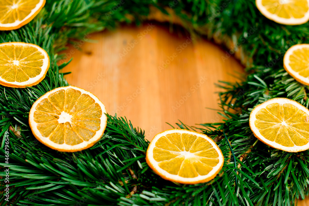 Christmas wreath of fir branches decorated with dried orange slices. Advent ornaments. Christmas wreath of fir branches decorated with dried orange slices. Advent ornaments.