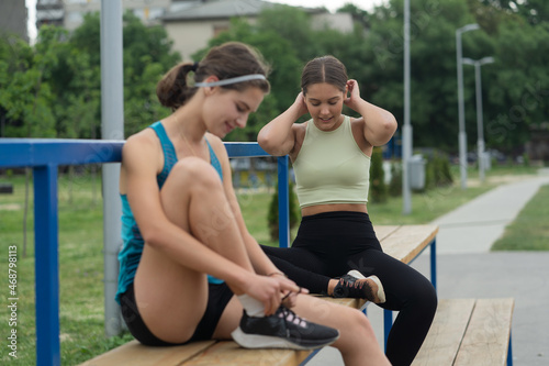 Talking while fixing her shoe laces