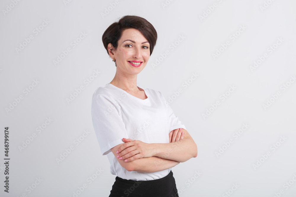 Happy young adult woman smiling with white teeth. Beautiful female model in 40s posing in studio wearing casual white t-shirt, classic bob haircut, makeup and red lipstick Happy young adult woman smiling with white teeth. Beautiful female model in 40s posing in studio wearing casual white t-shirt, classic bob haircut, makeup and red lipstick
