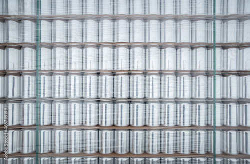 Aluminum cans for drinks stacked on shelf in warehouse. New unused aluminium for cold beverages